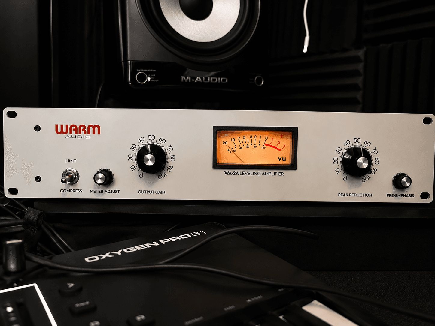 Warm Audio WA-2A leveling amplifier featuring a glowing orange VU meter and silver faceplate.